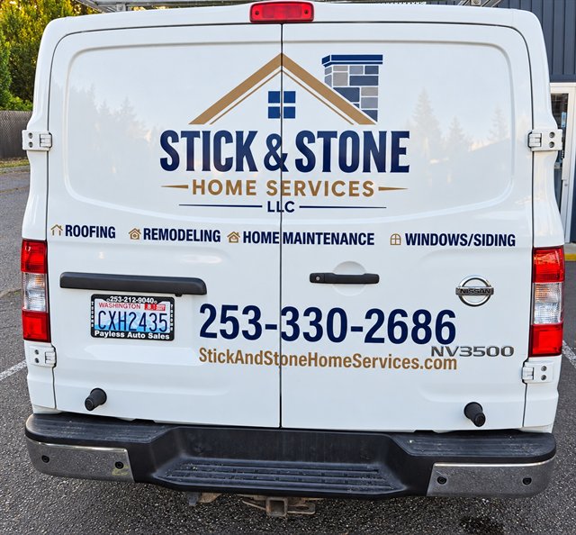 Rear of the Stick & Stone work van with the company logo and business phone number